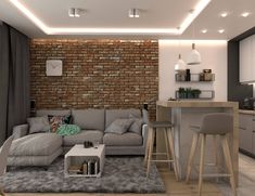 a living room filled with furniture and a brick wall behind the couch is a bar