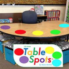 a table with colorful polka dots on it in front of a bookcase and bookshelf