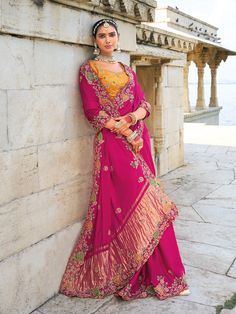 Transform your wardrobe with this breathtaking Rani Pink Satin Silk Saree, adorned with intricate Jari, Thread, Cut-Dana, Moti, and Jarkhan heavy work. Paired with a Banarasi Silk blouse in matching Rani Pink, this ensemble is the epitome of timeless elegance for grand celebrations. Versatility in Shades and FabricsThe luminous satin silk fabric in vibrant Rani Pink offers a luxurious sheen, while the Banarasi Silk blouse enhances the ensemble with its traditional richness. Perfect for weddings, festive occasions, or cultural gatherings, this saree effortlessly blends versatility with sophistication. Traditional CraftsmanshipCrafted with impeccable attention to detail, the saree features heavy Jari, Thread, and Cut-Dana work, accentuated by delicate Moti and Jarkhan embellishments. Each el Contemporary Saree, Satin Silk Saree, Reception Saree, Rani Pink, Bollywood Saree, Satin Silk, Pink Saree, Women Wedding Guest Dresses