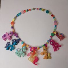 A colorful charm necklace made from real My Little Pony mini figures. Complete with a rainbow assortment of plastic beads for a retro 1990's feel. Necklace is about 24 inches around. Necklace connects using a heart toggle clasp. I handcraft all my jewelry from scratch. All of my items are unique and one of a kind. I can, however, usually make something similar. Gyaru Journal, Charming Garden, Lovely Necklace, Plastic Beads, Toggle Clasp, Cute Earrings, Christmas List, Mini Figures, My Little Pony