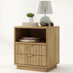 a small wooden cabinet with two drawers and a lamp on the side table next to it