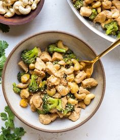 two bowls filled with chicken, broccoli and cashews