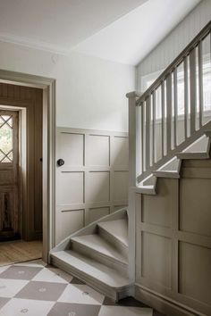 an empty room with stairs leading up to the door