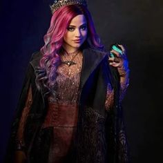 a woman with long pink hair wearing a crown and holding a ring in her hand