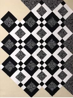 a black and white quilt with squares on it