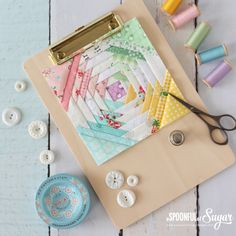 sewing supplies are laid out on a table next to some scissors and spools