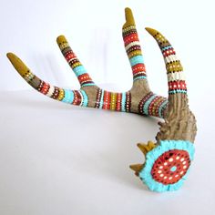 an animal's antlers are decorated with beaded designs and beads on them