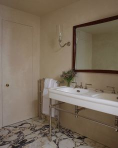 a bathroom with two sinks and a mirror