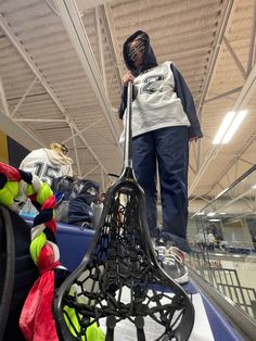 a person standing on top of an escalator with tennis rackets in front of them