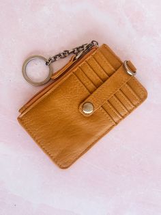 The Dolly Keyring Card Wallet is the perfect companion for your daily adventures. With its compact size and convenient keyring, you'll never have to rummage through your bag again. Say goodbye to bulky wallets and hello to effortless organization! 4 colors to choose from. Details: Dimensions: 5 in. H x 3.25 in. W x .25 in. D Top zip closure/pocket 5 Credit card slots with snap tab closure 1 ID Window 1 Interior Key Ring Brass plated hardware Small Cards, Say Goodbye, You Bag, Key Ring, Key Rings, Card Wallet, Card Slots, Slots, Wallets