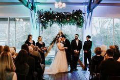 a bride and groom are getting married in front of an audience at their wedding ceremony