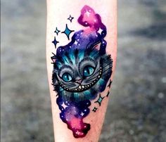 a cat with blue eyes and stars on it's leg is shown in this colorful tattoo