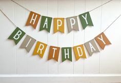 a happy birthday banner hanging on the wall