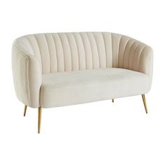 a cream colored couch with wooden legs