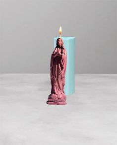 a candle that is in the shape of a statue