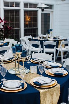 the table is set with blue and gold plates