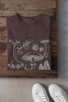 Thanks for stopping by! Cottagecore Mushroom T-shirt Printed on a super soft, cotton tee Dispatched in 5 working days or sooner Unisex Free UK delivery Material: 100% ringspun cotton. Chest (to fit): S  34/36   M  38   L  40/42   XL  44/46   XXL  48/50 ECO-FRIENDLY Each garment is made to order, reducing extra material and energy that would be otherwise wasted We use DTG printing process which is easier on the environment than screen-printing Our ink is bright and also eco-friendly. Do not tumbl