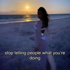 a woman standing on top of a sandy beach next to the ocean at sunset with an inspirational quote