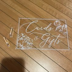 a clear sign that says cards and gifts on the floor