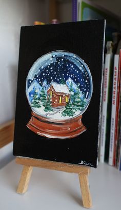 a snow globe sitting on top of a wooden easel