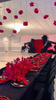 a long table is set with red and black decorations