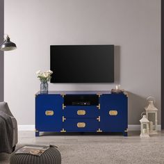 a living room with a television and blue cabinet