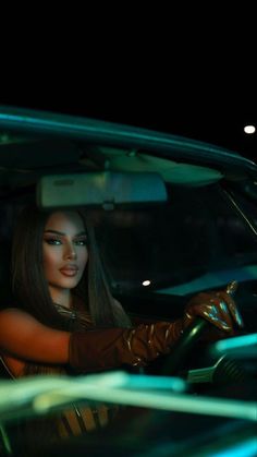 a woman sitting in the driver's seat of a car