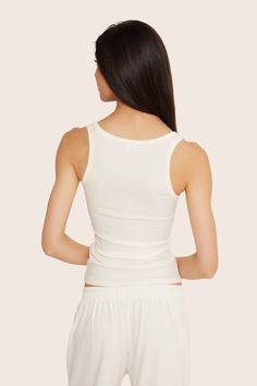 Stay stylish and comfortable with the Ribbed Modal Body Tank in Blanc. This fitted full-length tank top features a rounded square front neckline and full coverage back, crafted from luxurious ribbed modal fabric. Fitted Ribbed Tank Top With Scoop Neck, Fitted Ribbed Scoop Neck Tank Top, Fitted Scoop Neck Ribbed Tank Top, Seamless Modal Tank Top, Fitted Modal Camisole Tank Top, Fitted Ribbed Tank Top, Fitted Ribbed Camisole For Loungewear, Fitted Ribbed Tank Top For Loungewear, Summer Ribbed Modal Tank Top