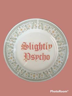 a white plate with red lettering on it that says slighin'dasho