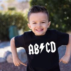 a young boy wearing a black t - shirt with the word abo printed on it