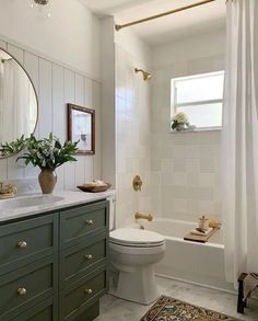 a bathroom with green cabinets and a white toilet