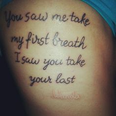 the back of a woman's stomach with words written in cursive writing