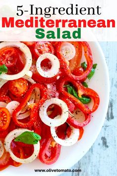 a white plate topped with sliced tomatoes and onions next to the words 5 ingredient mediterranean salad