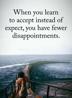 a woman standing on the edge of a pier next to the ocean with an inspirational quote