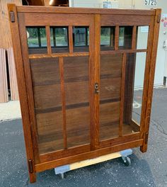 a wooden cabinet sitting on top of a dolly