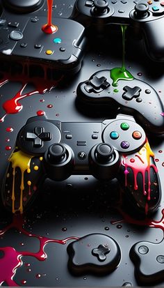 several video game controllers covered in paint and splattered on the surface, with blood running all over them