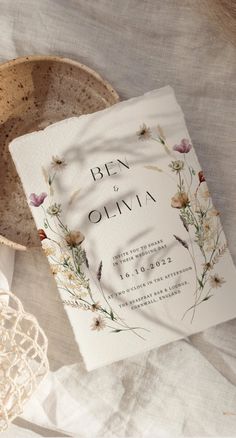 an open book sitting on top of a table next to a bowl and doily