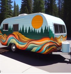 an old camper is painted with the sun and trees on it's side