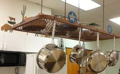 pots and pans hanging from hooks in a kitchen