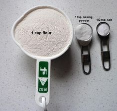 measuring spoons, measuring cup and measuring tape with instructions for baking flour in them