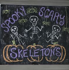 a chalk board with skeletons and pumpkins written on it that says scary scary skeleton's