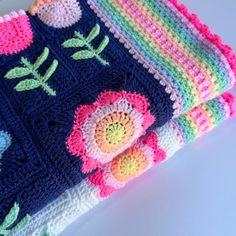 three crocheted dishcloths with flowers on them