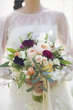 a woman holding a bouquet of flowers in her hands