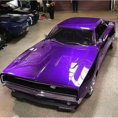 a purple muscle car parked in a garage