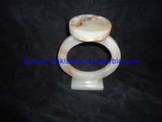 a white marble ring with a shell on it's center and an oval stone in the middle