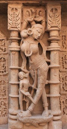 an intricately carved statue on the side of a building