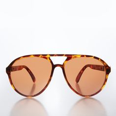 This basic classic sunglasses feature a tear drop frame with gold accent temples eye pleasing copper lens. New old stock. Never worn. Great condition. UV protection. NOS deadstock Made in Taiwan FIT INFORMATION 58mm Eye Size 20mm Bridge 140mm Temple/Arm Width 5 3/4 Inches Height 2 1/4 Inches Shop more Vintage Sunglasses @ https://www.etsy.com/shop/SunglassMuseum Shop more Vintage Reading Glasses @ https://www.etsy.com/shop/RetroVintageReaders Retro Brown Aviator Sunglasses With Uva Protection, Vintage Brown Aviator Sunglasses With Gradient Lenses, Vintage Brown Aviator Sunglasses With Polarized Lenses, Vintage Brown Aviator Sunglasses With Anti-reflective Coating, Vintage Brown Aviator Sunglasses With Uva Protection, Steampunk Woman, Classic Sunglasses, Pilot Sunglasses, Wholesale Gifts