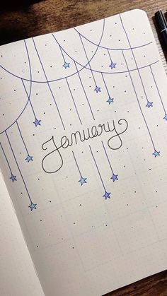 an open notebook with the word january written in cursive writing and stars on it