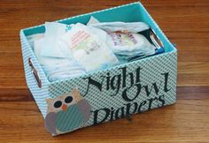 an open box with diapers in it on a wooden floor