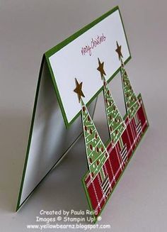 a folded christmas card with trees on it